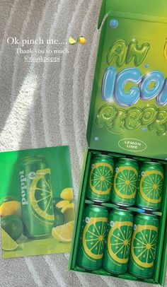 an open box of soda with lemons and limes on the inside, sitting on a towel