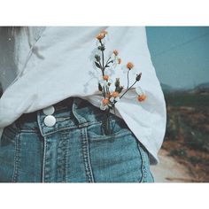 a person with flowers in their back pocket