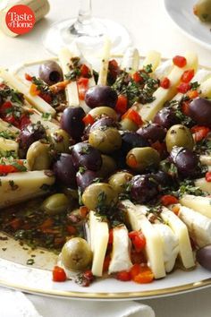 a platter filled with cheese and olives