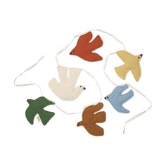 four different colored birds on white string