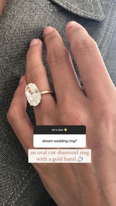 a person wearing a ring with a diamond on it's finger and the text dream wedding? an oval cut diamond ring is being held by a gold band