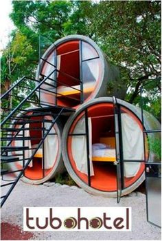 an unusual bed in the shape of a house with spiral stairs and round beds on each side