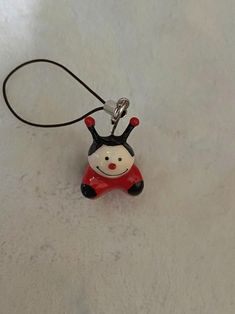 a small red and black toy with a white face on it's back end