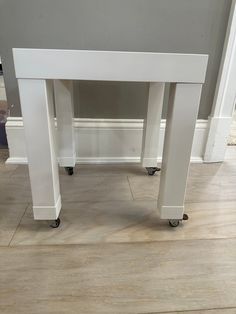 a white desk sitting on top of a hard wood floor