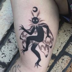 a black and white tattoo on the leg of a person with a lizard crawling across it