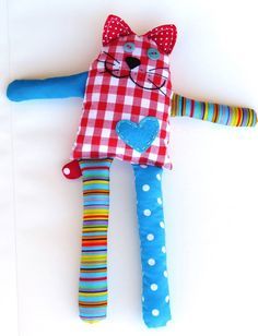 a colorful stuffed animal laying on top of a white surface next to a blue toothbrush