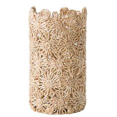 a white vase that is made out of wood and has an intricate design on it