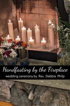 there are many vases with flowers and candles in front of the fireplace that is lit