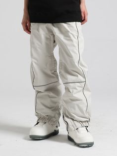 a person wearing white pants with black trims on the legs and feet, standing in front of a white background