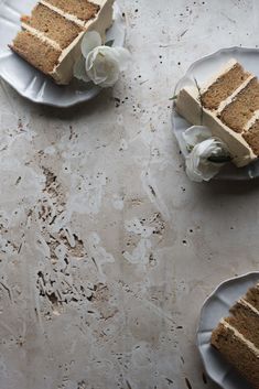 three slices of cake sitting on top of plates with flowers in the middle of them