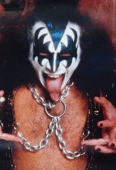 a man with his tongue out and face painted like the kiss band's demon