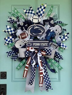 a wreath made out of footballs and other sports related items is hanging on the front door