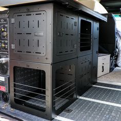 the back end of a truck with two ovens in it's cargo area