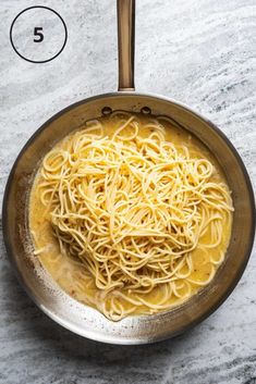 a pan filled with noodles on top of a table