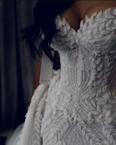 the back of a wedding dress with beading on it