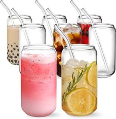 there are many different drinks in glass jars with straws on the top and bottom