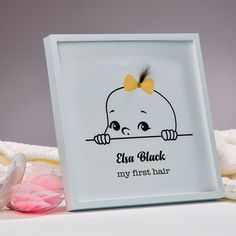 an image of a baby's first hair on display in a frame with the words, i am black my first hair