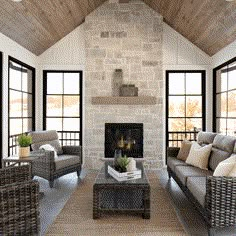 a living room filled with lots of furniture next to a fire place in a building