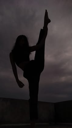 a person doing a trick on a skateboard in the air with their arms outstretched