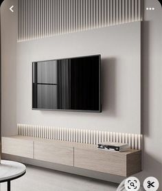 a flat screen tv mounted to the side of a white wall in a living room