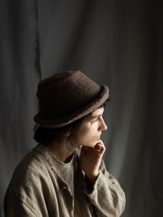 Handmade woolen hat CLAY Minimalist hat made of 100% wool inside and outside. Looks like felted raw texture wool. Color is greyish brown, desaturated and natural. This hat is dense and warm, keeps it shape and suits autumn and winter. It's possible to turn brim up and down. Brim and top of the hat are hand stitched with natural linen thread. All the materials are prewashed to avoid shrinkage. Suitable for women or men. Rustic Minimalist, Felted Hat, Linen Shawl, Brown Hat, Greyish Brown, Brown Hats, Wool Caps, Linen Scarves, Unique Hats