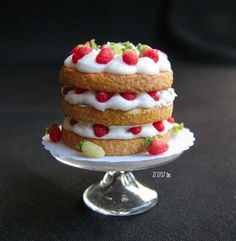 there is a three layer cake with strawberries on top