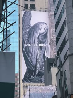 an advertisement for saint laurent on the side of a building