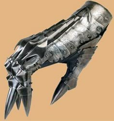 a metal object that looks like a dragon's head with spikes and claws on it