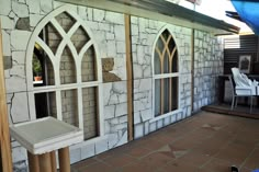 an outside view of a house that has been painted white and is being used as a patio