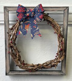 a wreath with a bow hanging on a wall