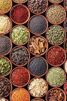 many bowls filled with different types of spices and seasonings on top of each other