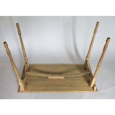 an old wooden tray with two sticks sticking out of it