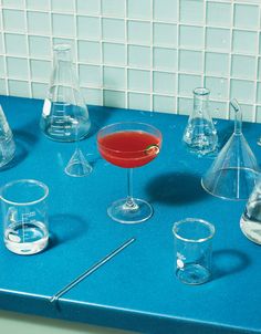 a blue counter topped with glasses and beakers