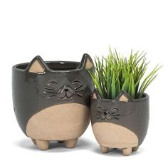 two ceramic cat planters sitting next to each other