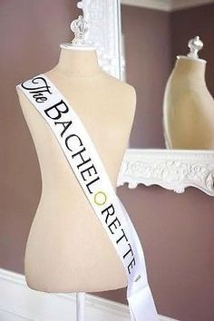 a mannequin with a white ribbon that says,'the bachelor'on it