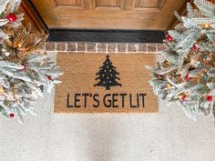 two christmas wreaths on the front door with let's get lit