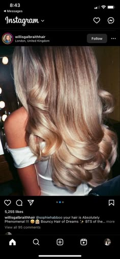 the back of a woman's head with long, blonde hair and wavy curls