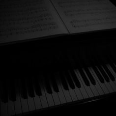 an open book sitting on top of a piano