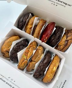 an open box filled with different types of cookies and muffins on top of each other