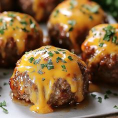 meatballs covered in cheese and garnished with parsley