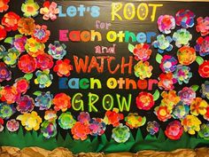 a bulletin board with flowers and words written on it that says, let's root for each other and watch each other grow