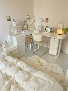 a bedroom with a bed, desk and computer on it's side in front of a white wall