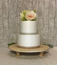 a three tiered white cake with flowers on top