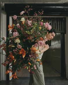 a woman holding a large bouquet of flowers