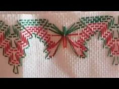 some red and green designs on a white cloth