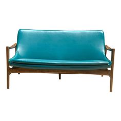 a blue leather couch sitting on top of a wooden frame