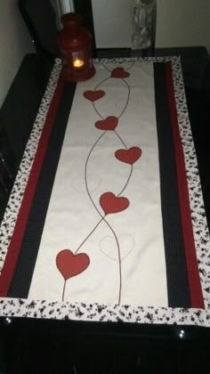 the table runner has hearts on it and is ready to be decorated with some candles