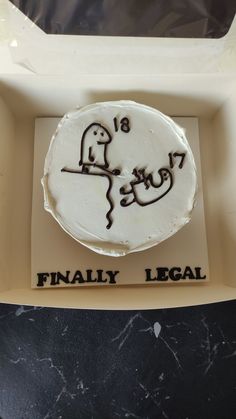 a cake in a box with the words finally legal written on it's side