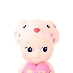 a small doll holding a pink heart with chinese writing on the front and back side