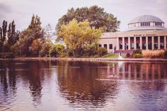 a large building sitting on the side of a lake